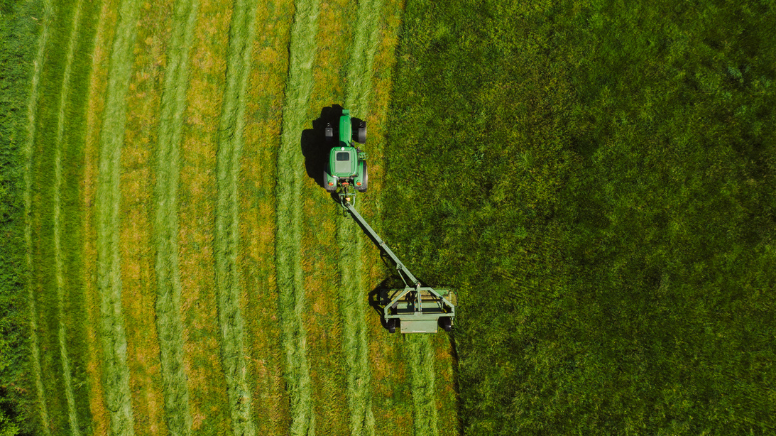 Top View Photo of Tractor Landscape Rake on Grass Field